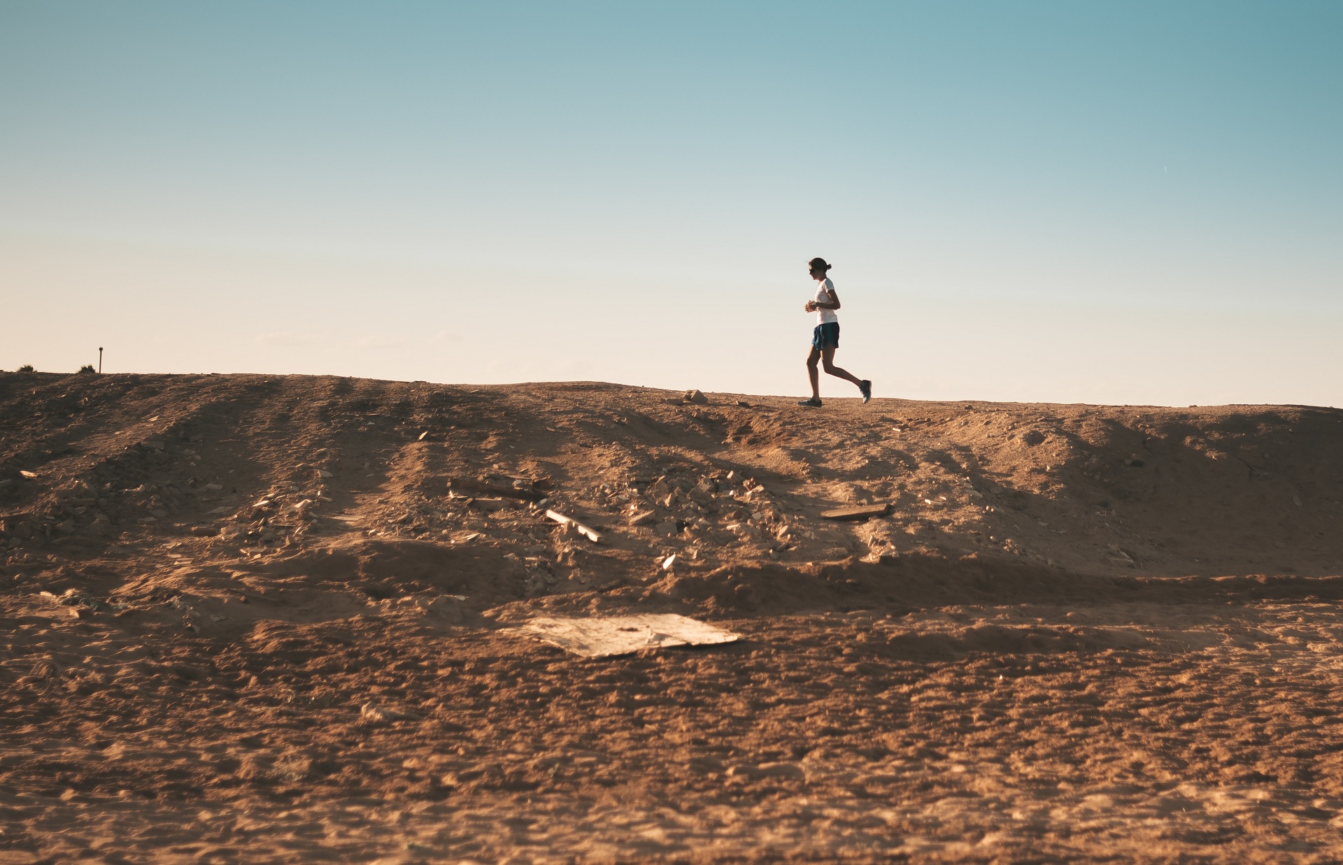 man running on a desert trail