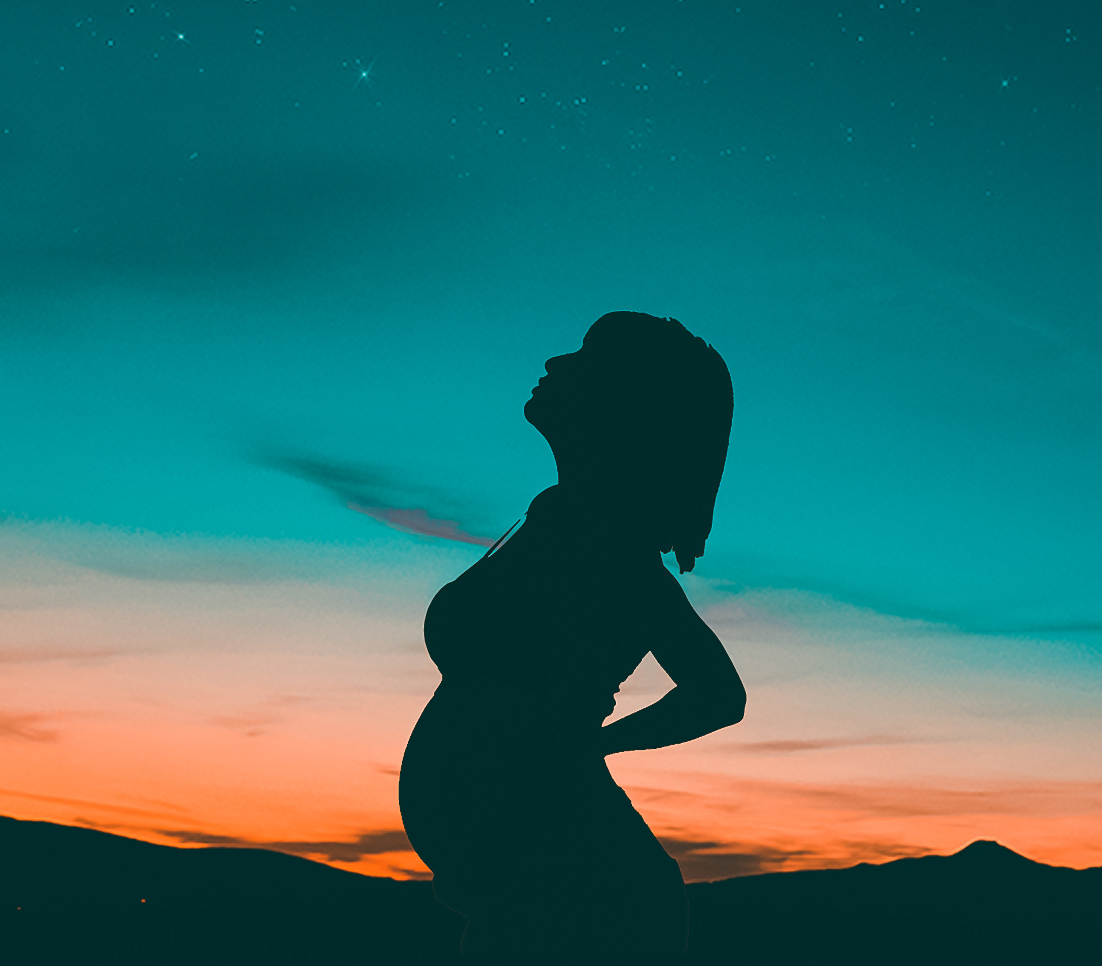 pregnant woman under a starry sky