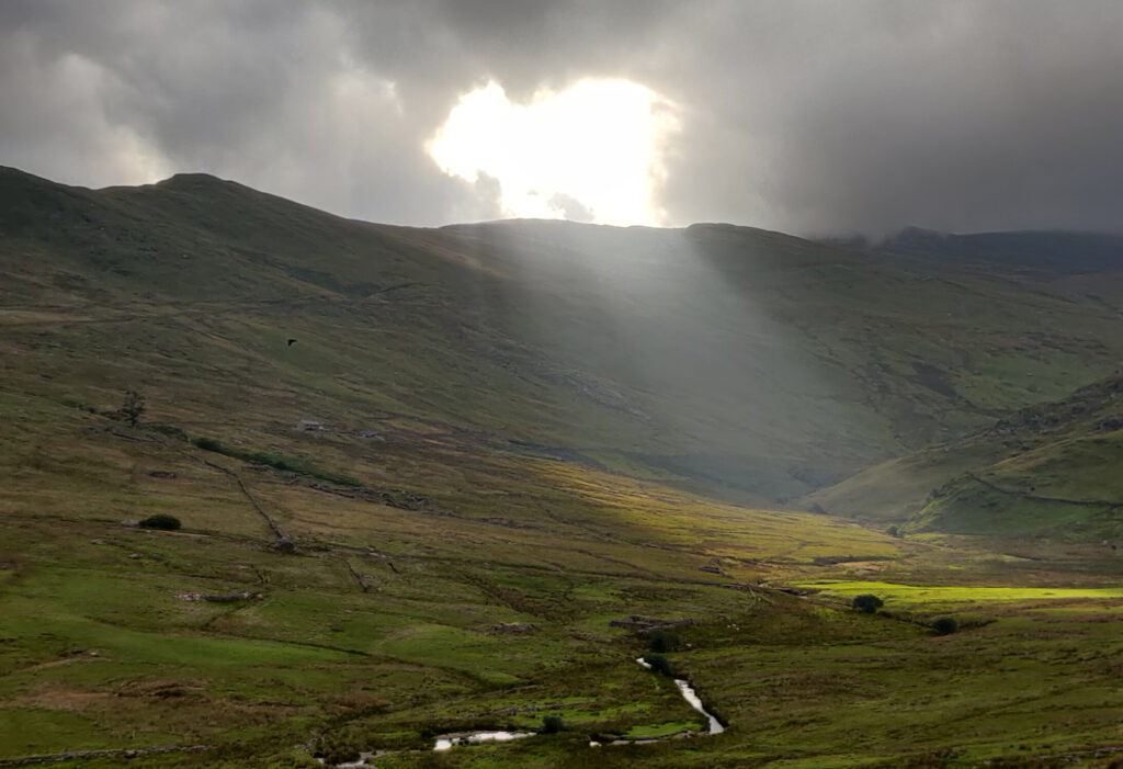 Telegraph valley, Snowdonia, sun shaft through the clouds. Making our way up to Moel Eilio.