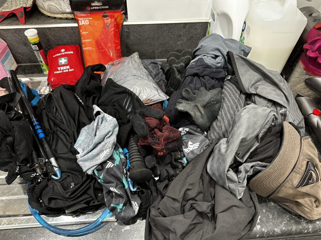 dirty and wet running gear laid out after my first 100 miler.