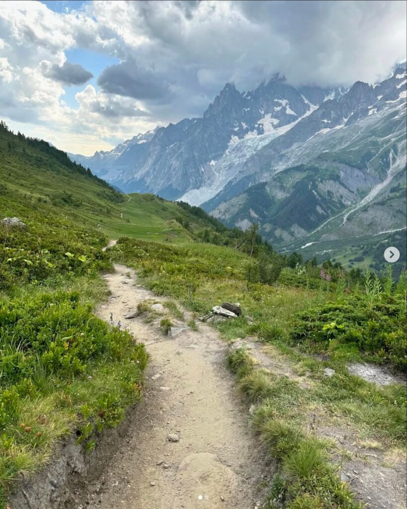 A trail leading off into the distance with glaciers around Courmayuer on the Tour du Mont Blanc route.