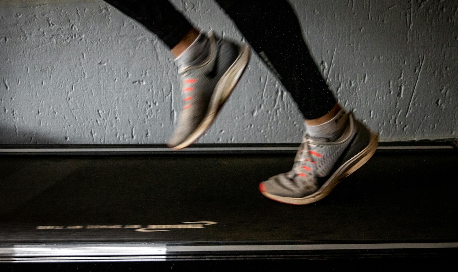 feet running on a treadmill